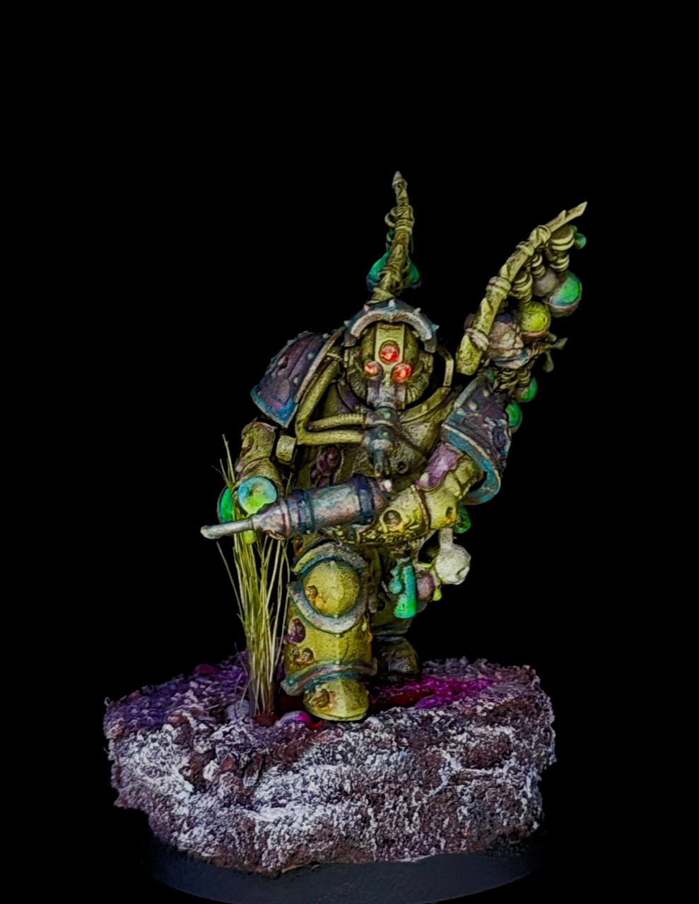 Close portrait of a painted plague-themed armored miniature on a scenic base against a dark background.